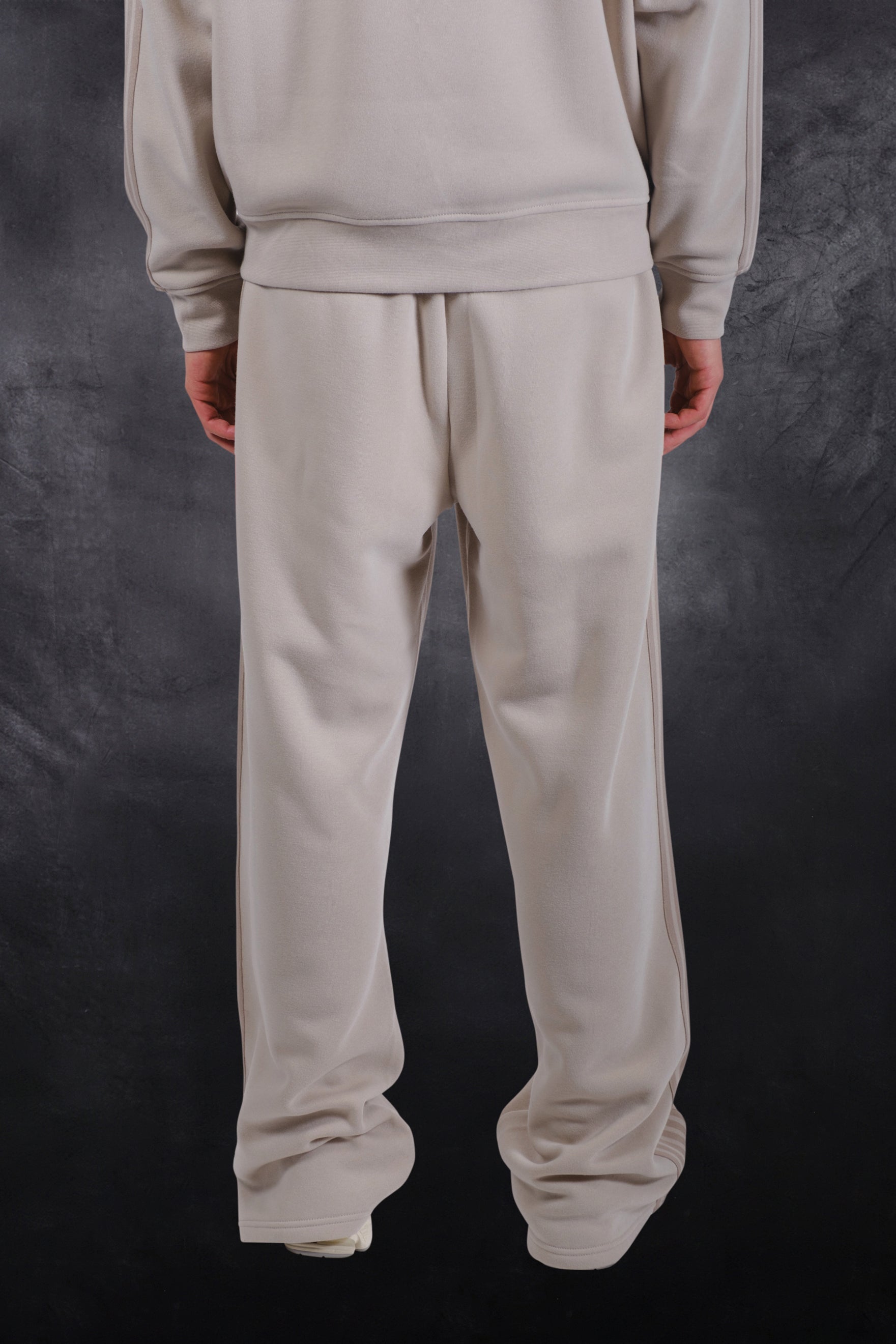 Cozy track pants made from fleece fabric and an adjustable drawstring waist
#color_sand
