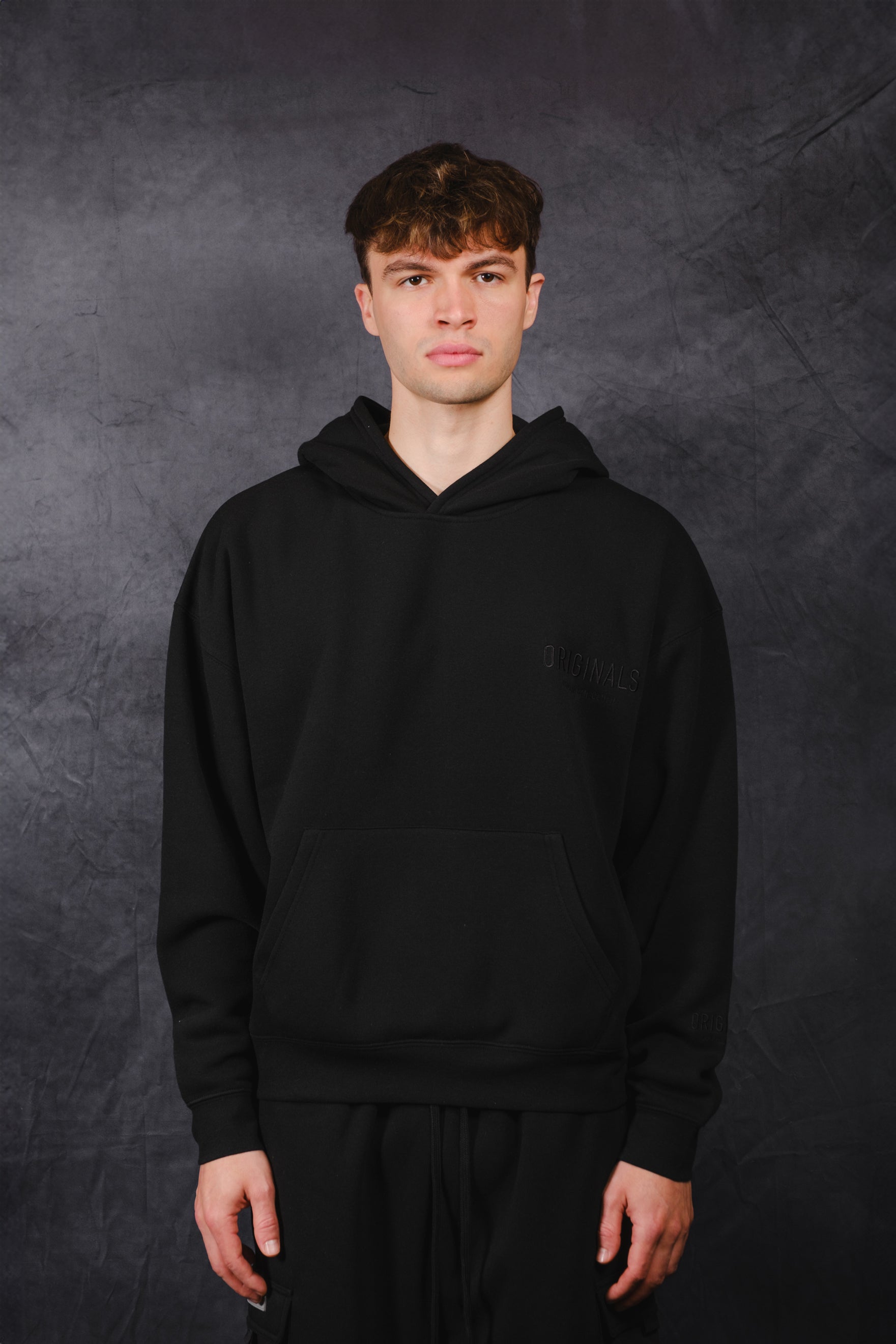 Casual oversized hoodie with tonal embroidery on chest
 #color_black