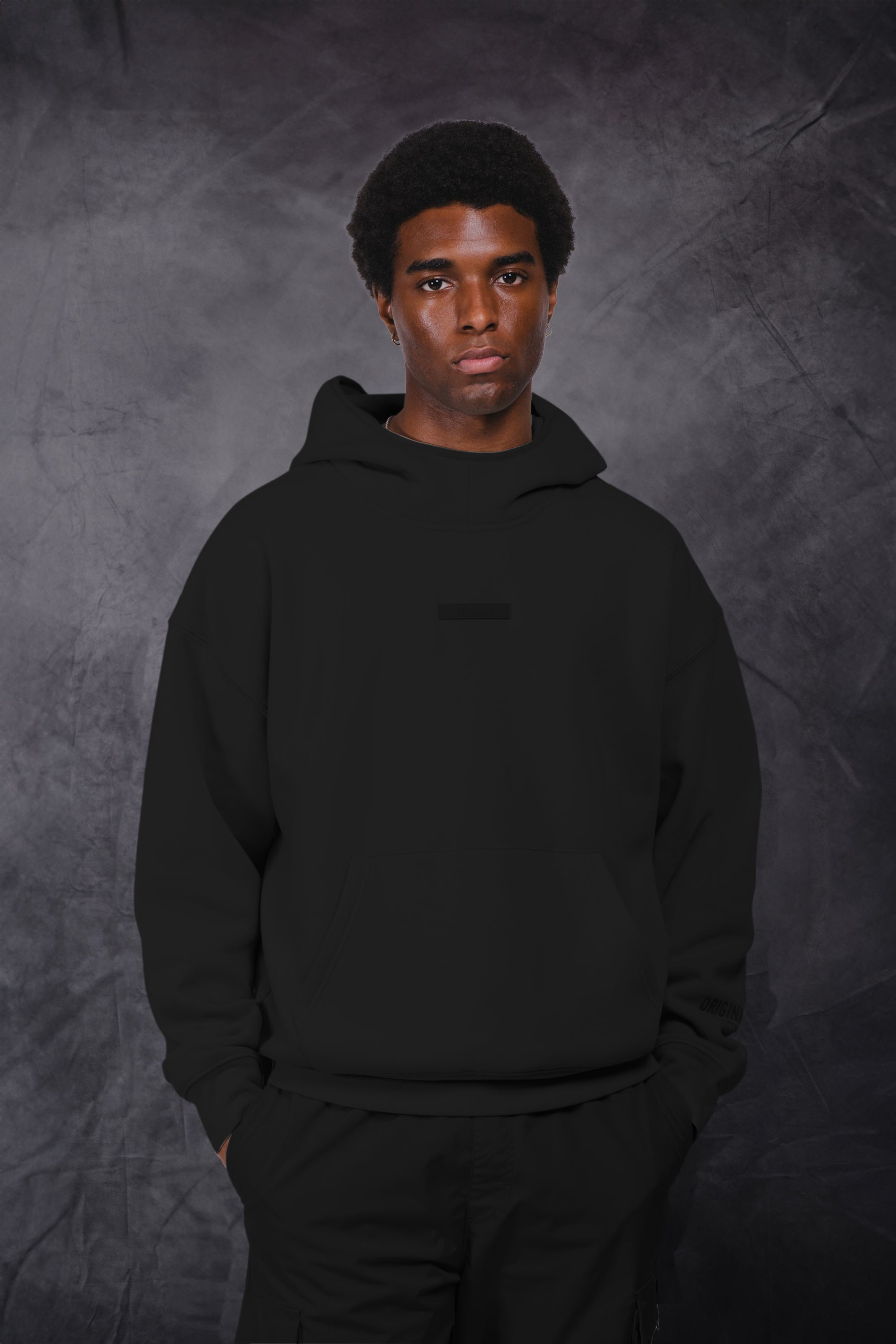 Men's black fleece long sleeve hoodie with originals patch logo on front with pocket. #color_black