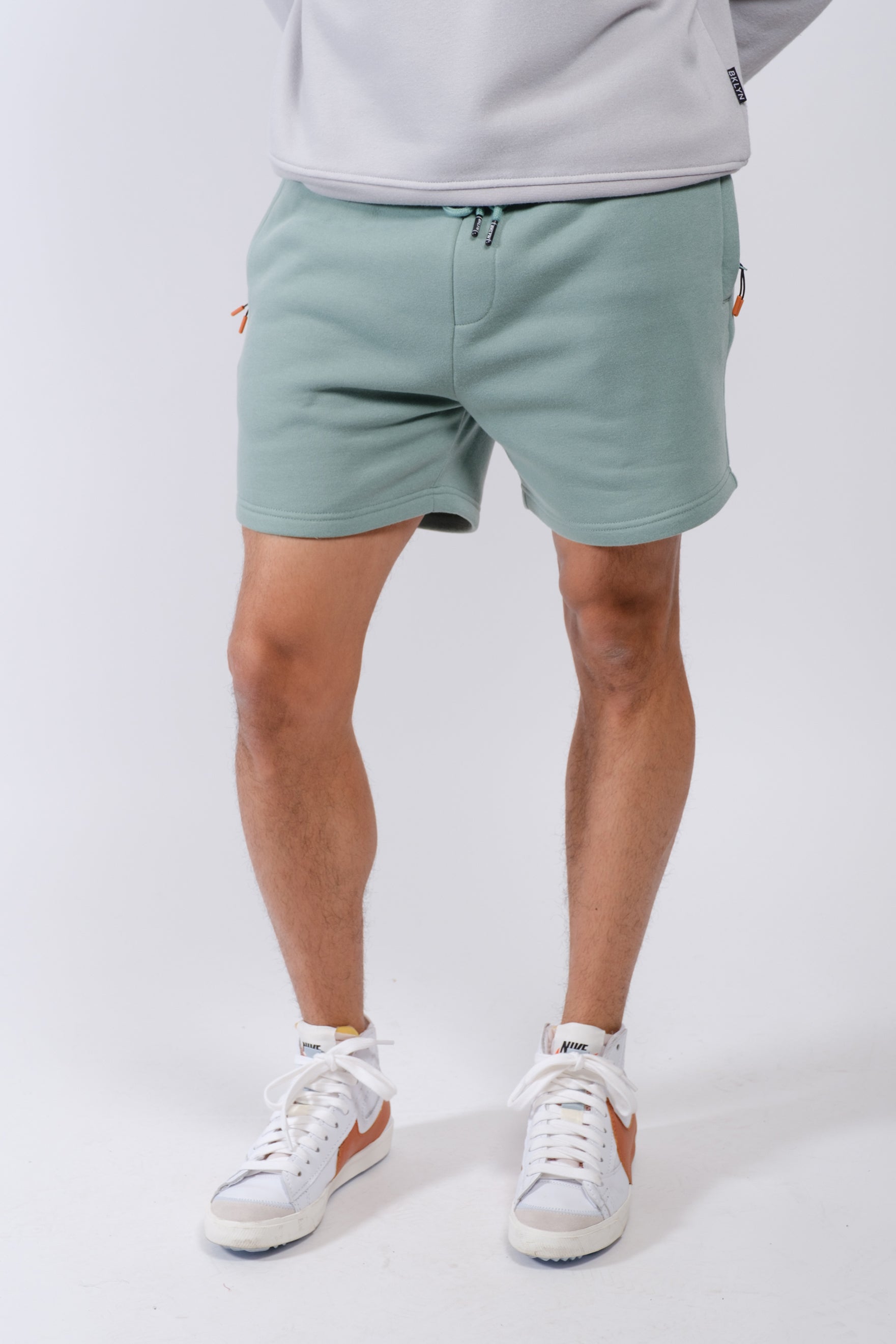 Men’s 5 inch inseam fleece shorts with zip pocket by Brooklyn Cloth
#color_soft moss
