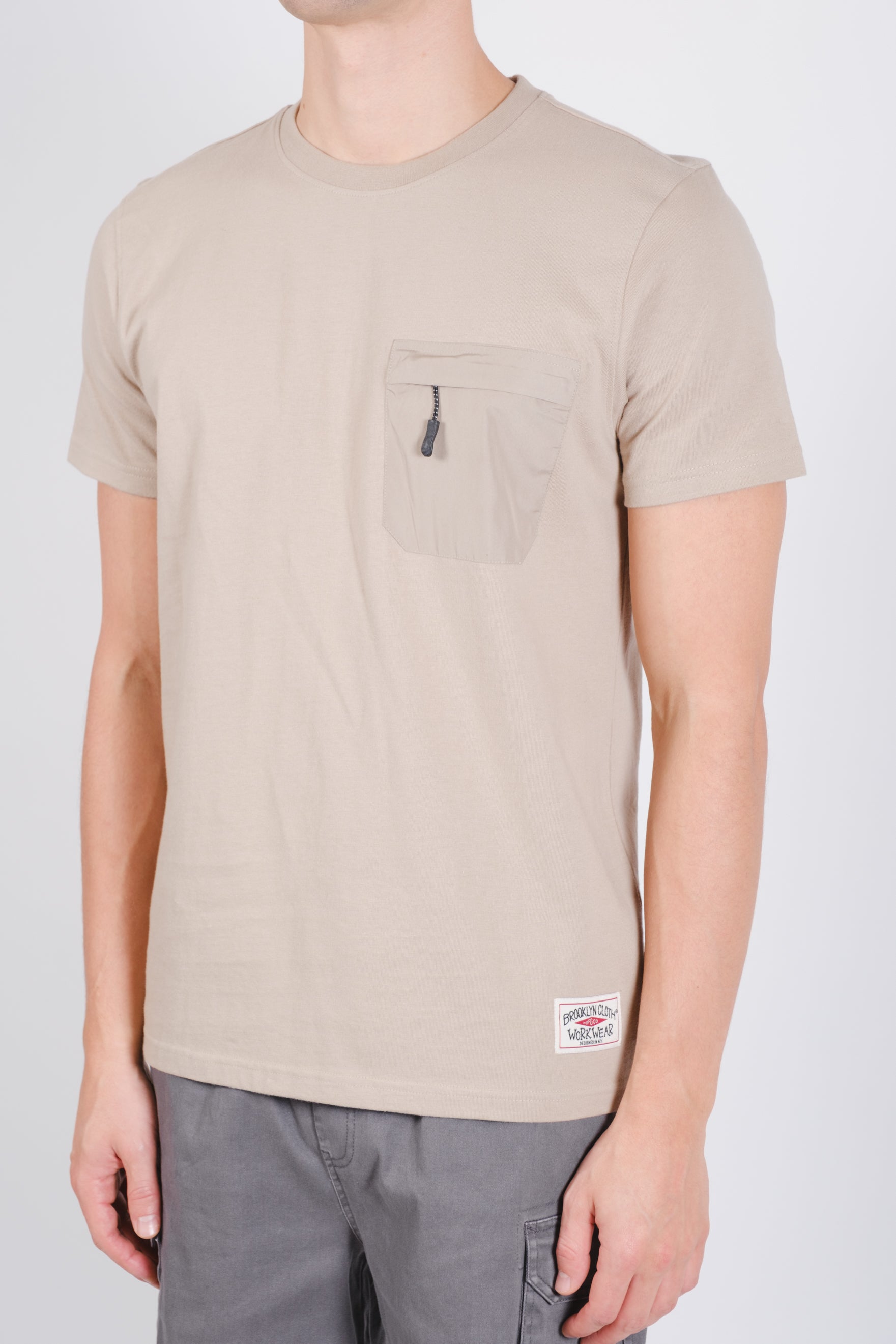Nylon tee with front zip pocket, classic fit, and short sleeves
#color_pumice stone