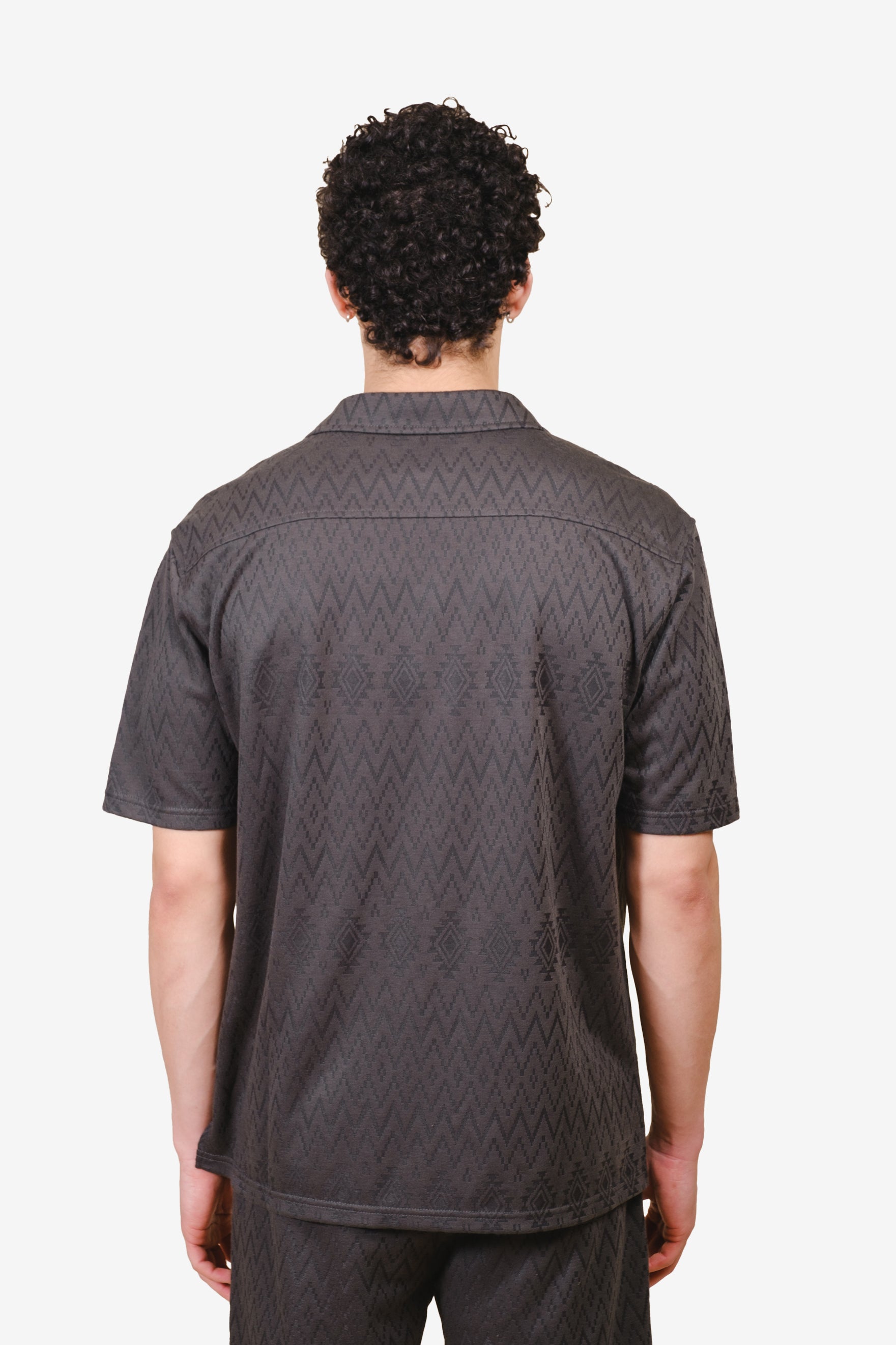 Aztec jacquard knit shirt with camp collar and button down closure
#color_dusty black
