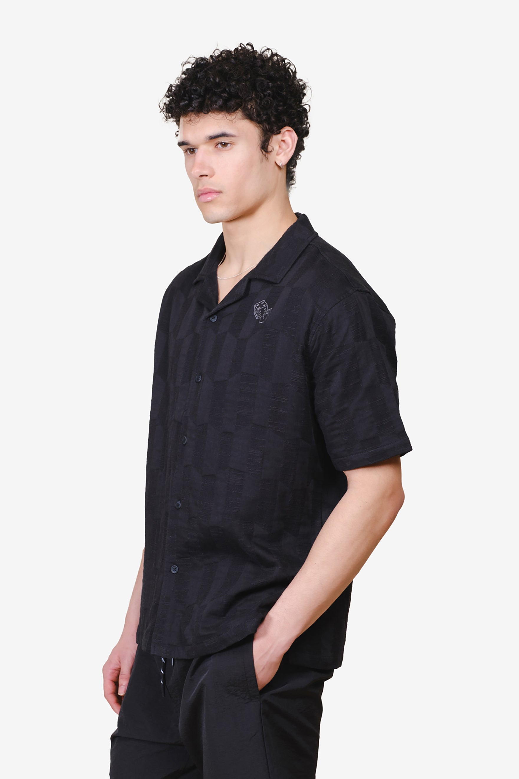 Woven Jacquard shirt with button down closure and embroidered dice detail
#color_black