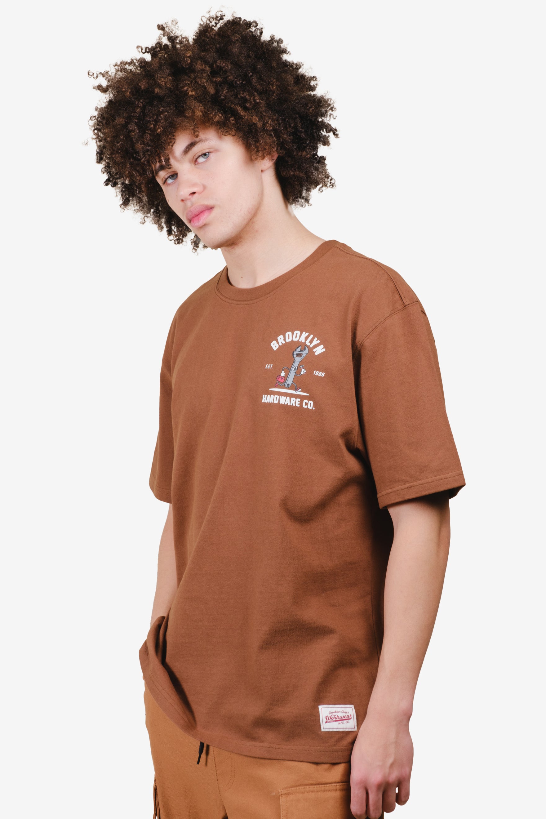 Men's Toffee relaxed fit t shirt with artwork and logo patch on bottom left #color_toffee
