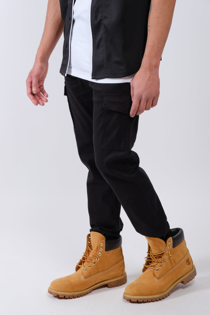 Men’s twill jogger pants in charcoal gray with side cargo pockets and relaxed fit
#color_black