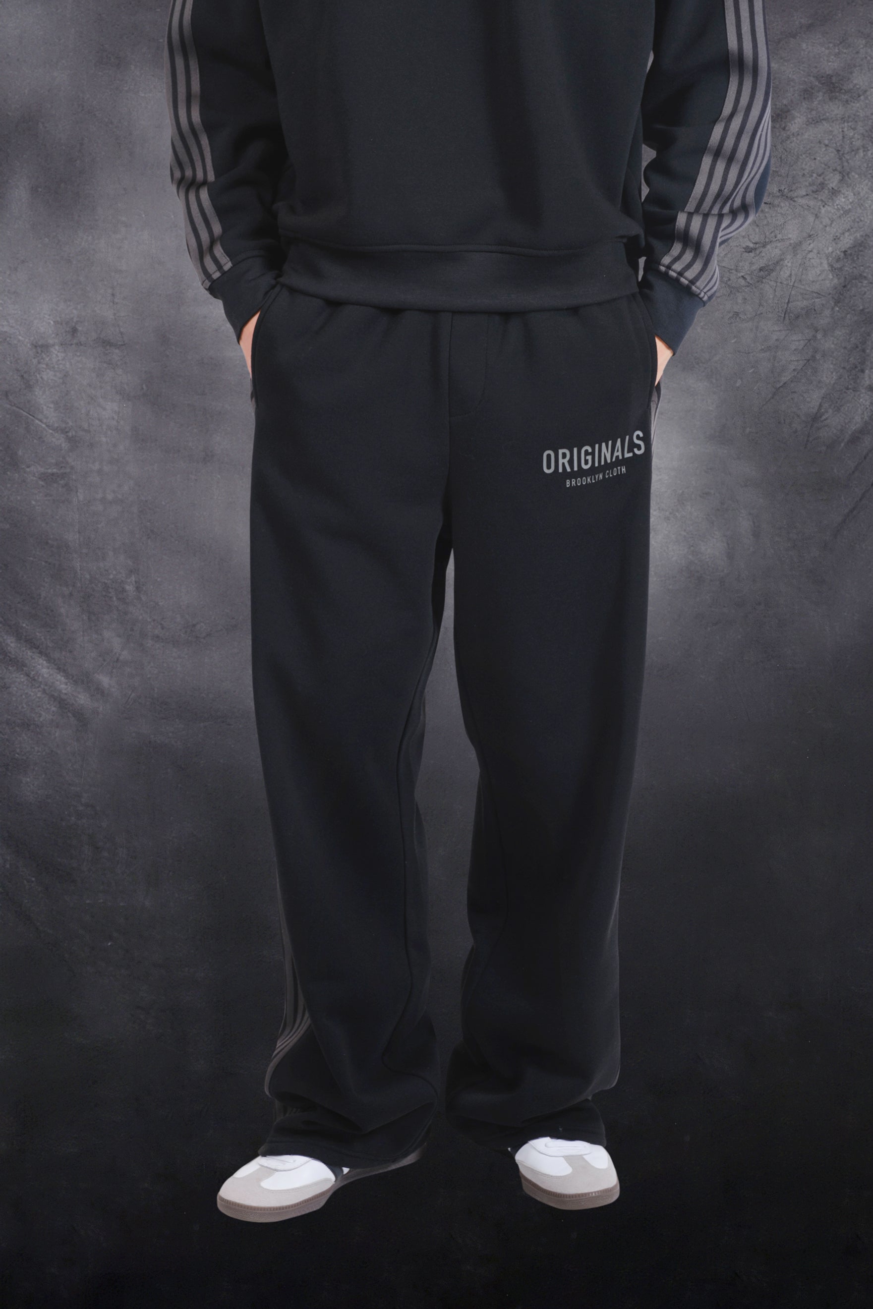 Stylish, men's fleece track pant with comfortable drawstring waist and logo #color_black