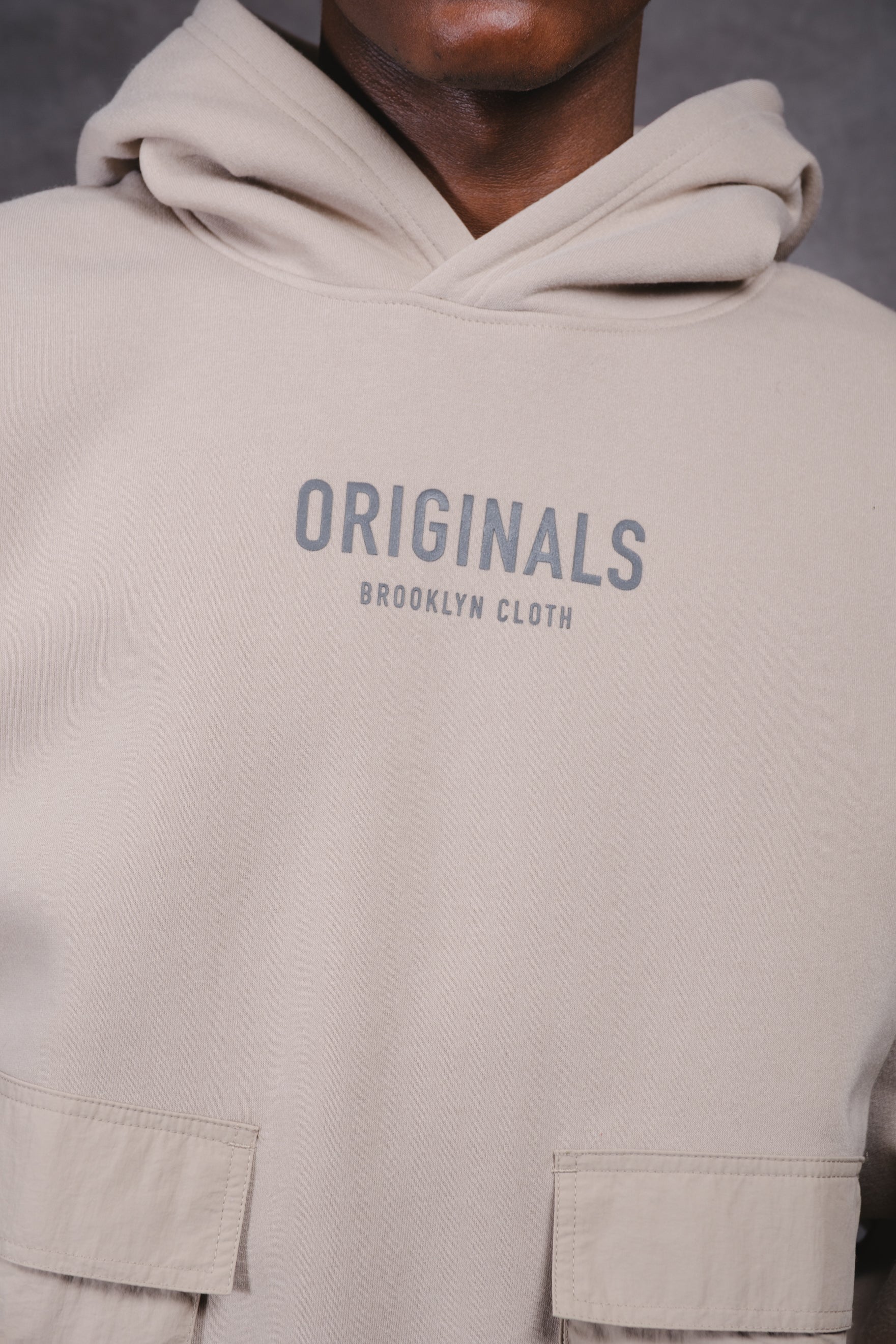 Originals Nylon Cargo Pocket Hoodie. #color_pumice stone