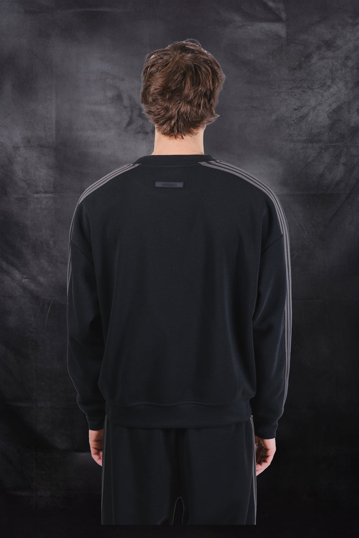 Crewneck track sweatshirt in black with rubber logo patch on back 
#color_black