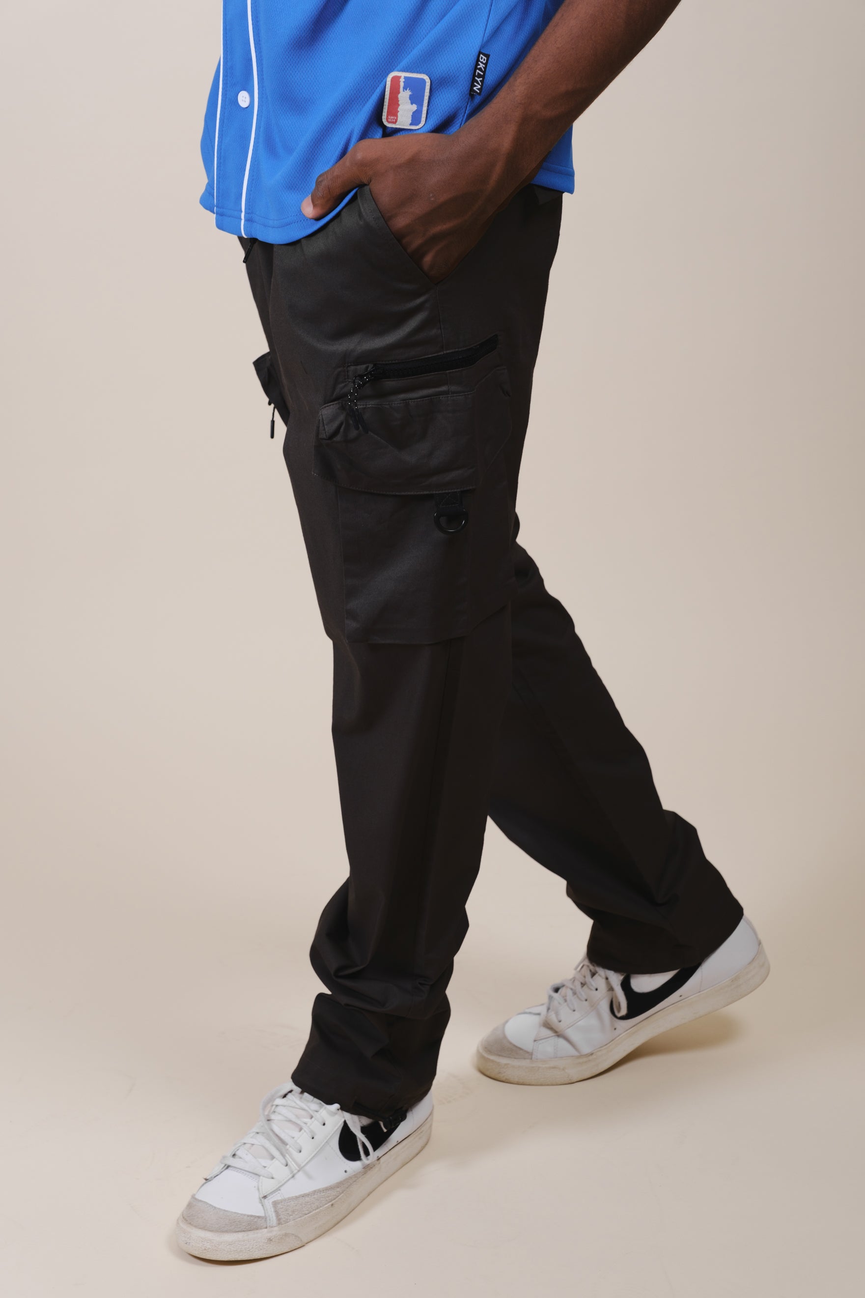 Relaxed fit poplin cargo pants for men featuring secure zip pocket detail
#color_black