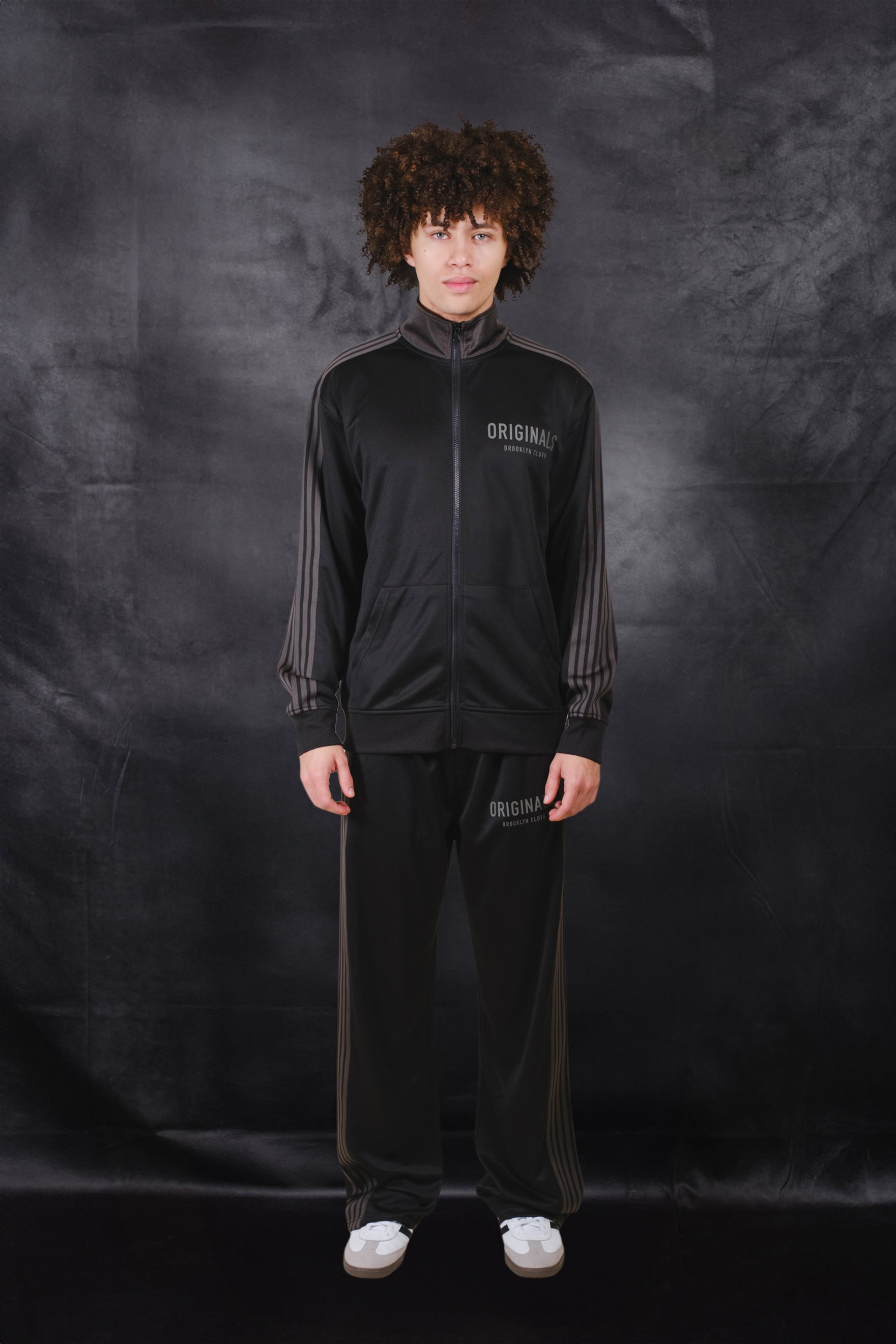 Loose fit men's Pique track pant with adjustable drawstring waist, side pockets and side strip panels
 #color_black