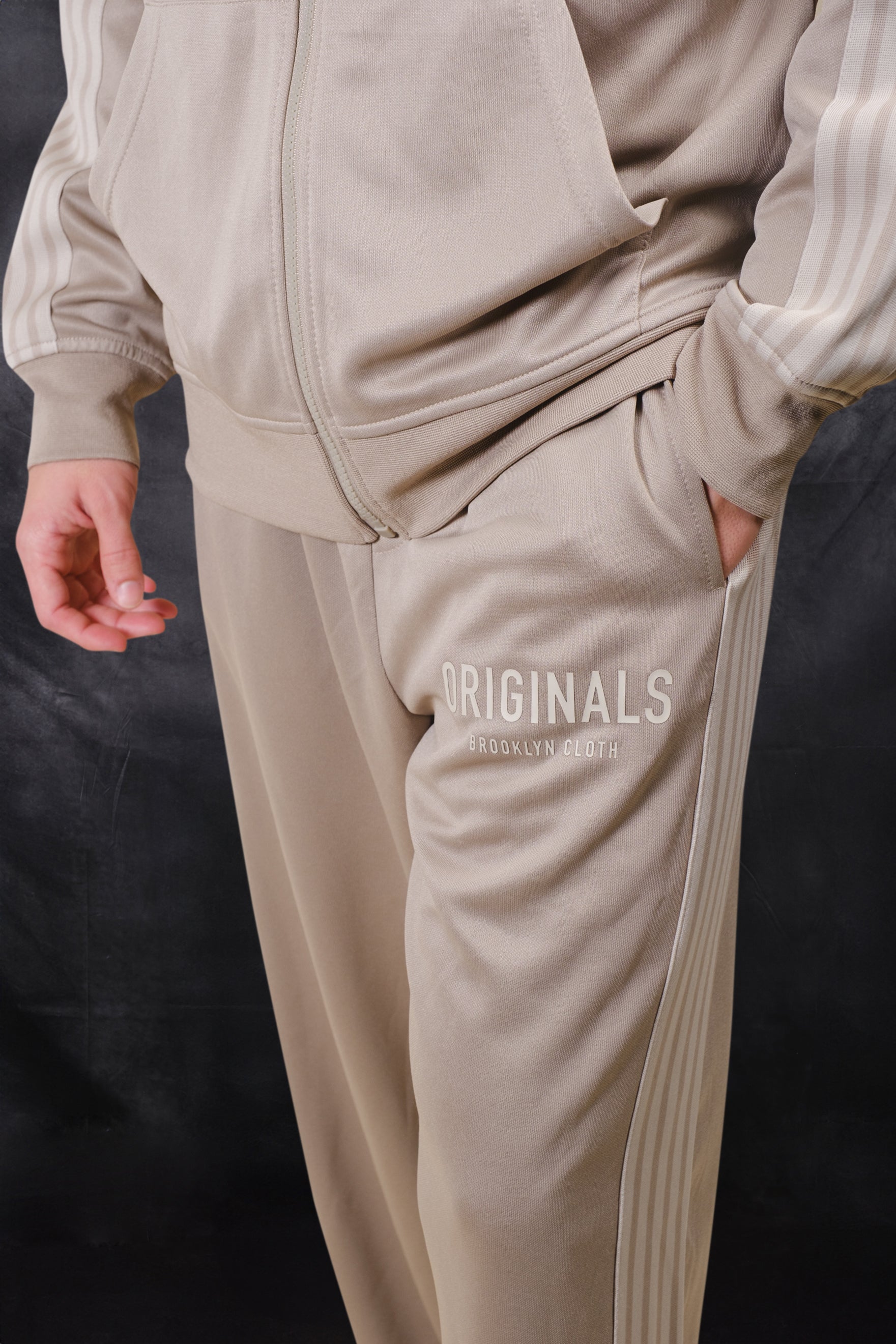 Originals Pique track pant in the color pumice stone with side strip panels and Originals logo on top left thigh #color_pumice stone