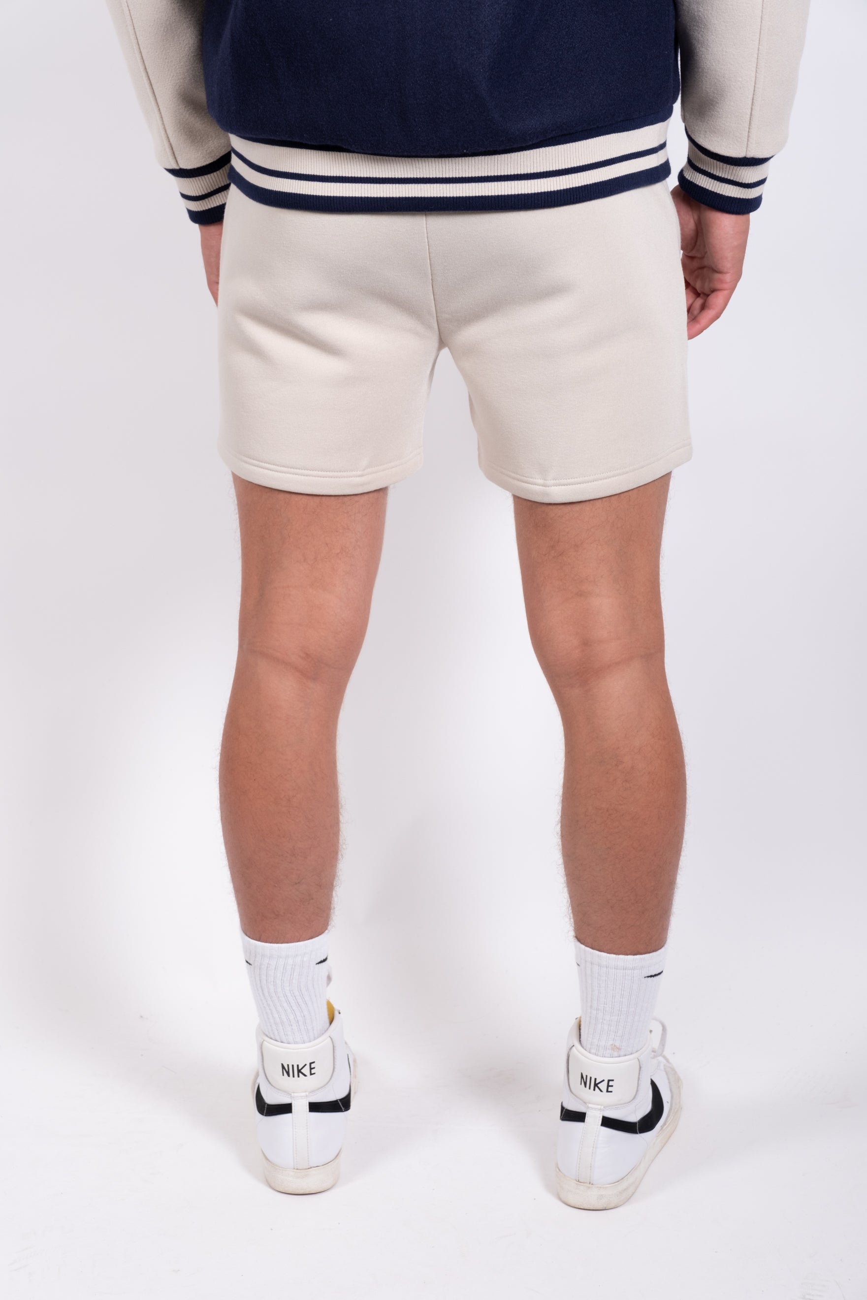 5-inch inseam shorts with zip pocket for men, available in black
#color_sand