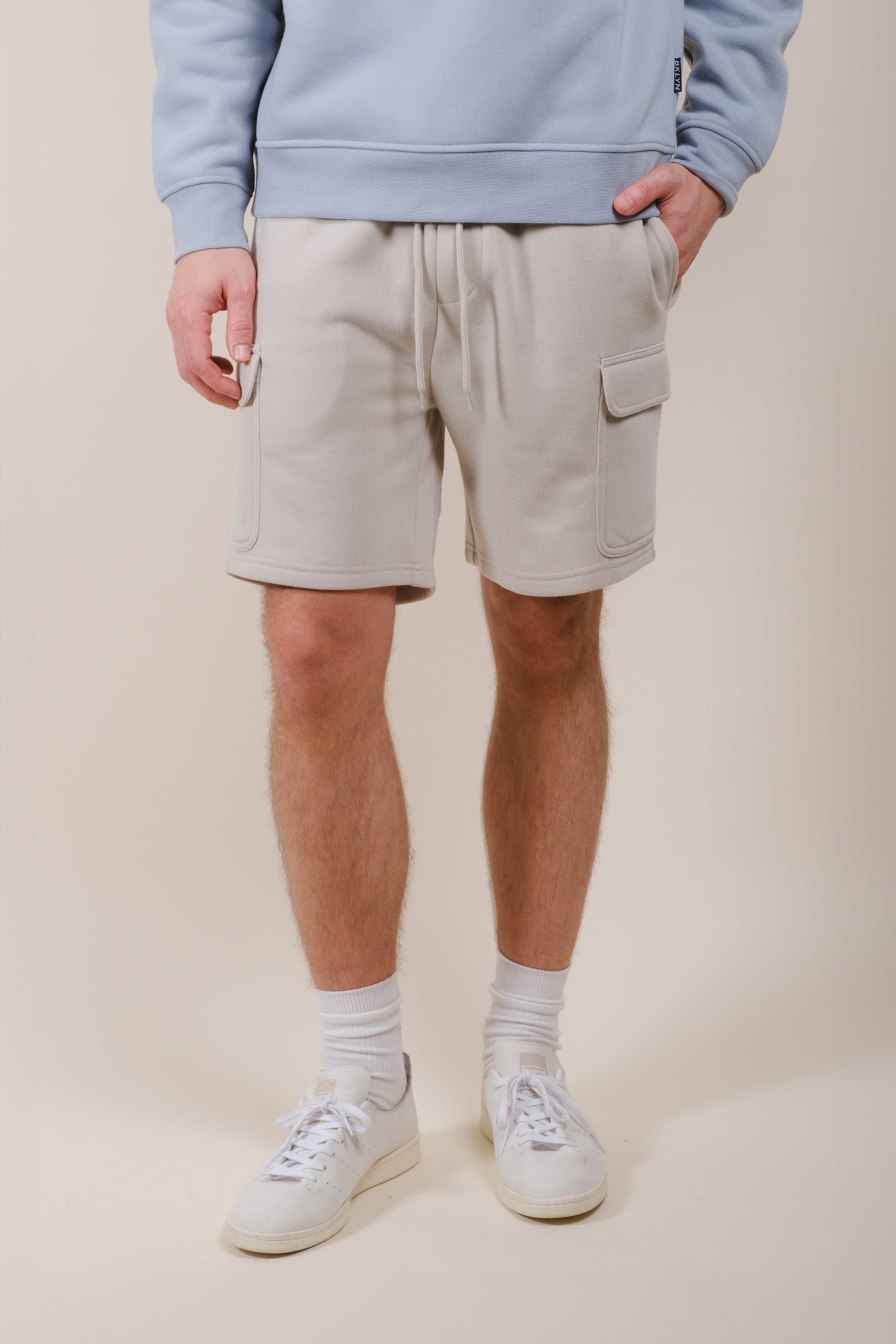 Men's cargo shorts with 7 inch inseam made from soft fleece
#color_sand