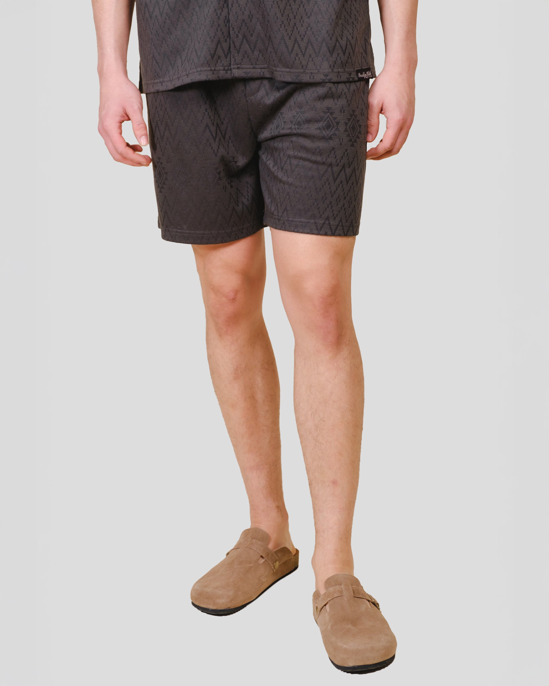 Mens dusty black knit shorts with an aztec jacquard pattern #color_dusty-black