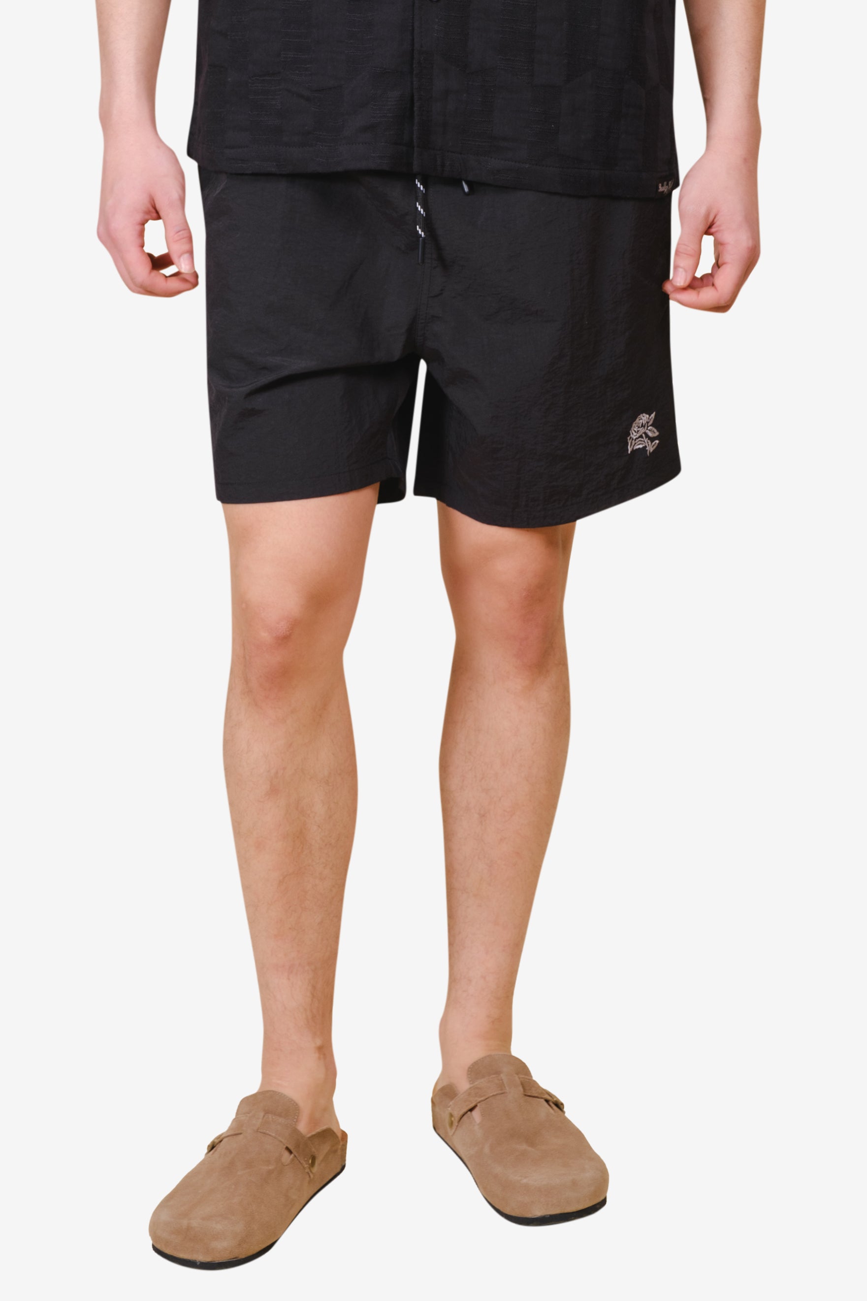 Men's monotone crinkle nylon shorts with flower detailing
#color_black