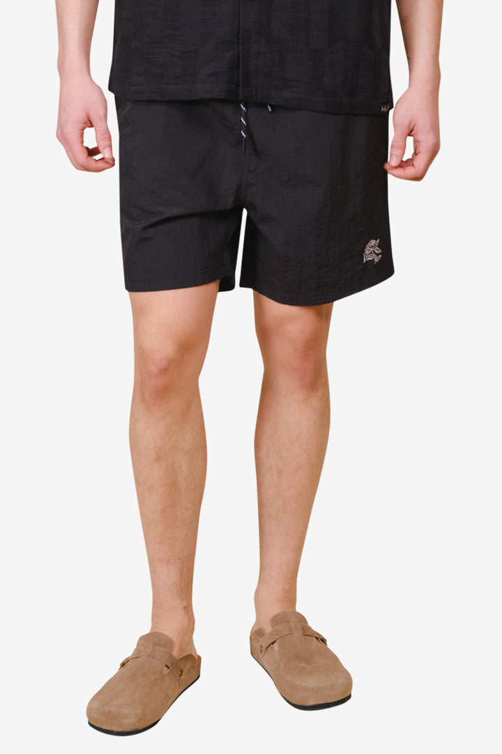 Men's monotone crinkle nylon shorts with flower detailing
#color_black