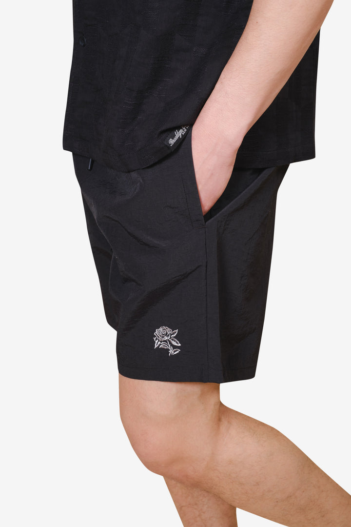 Men's monotone crinkle nylon shorts with flower detailing
 #color_black