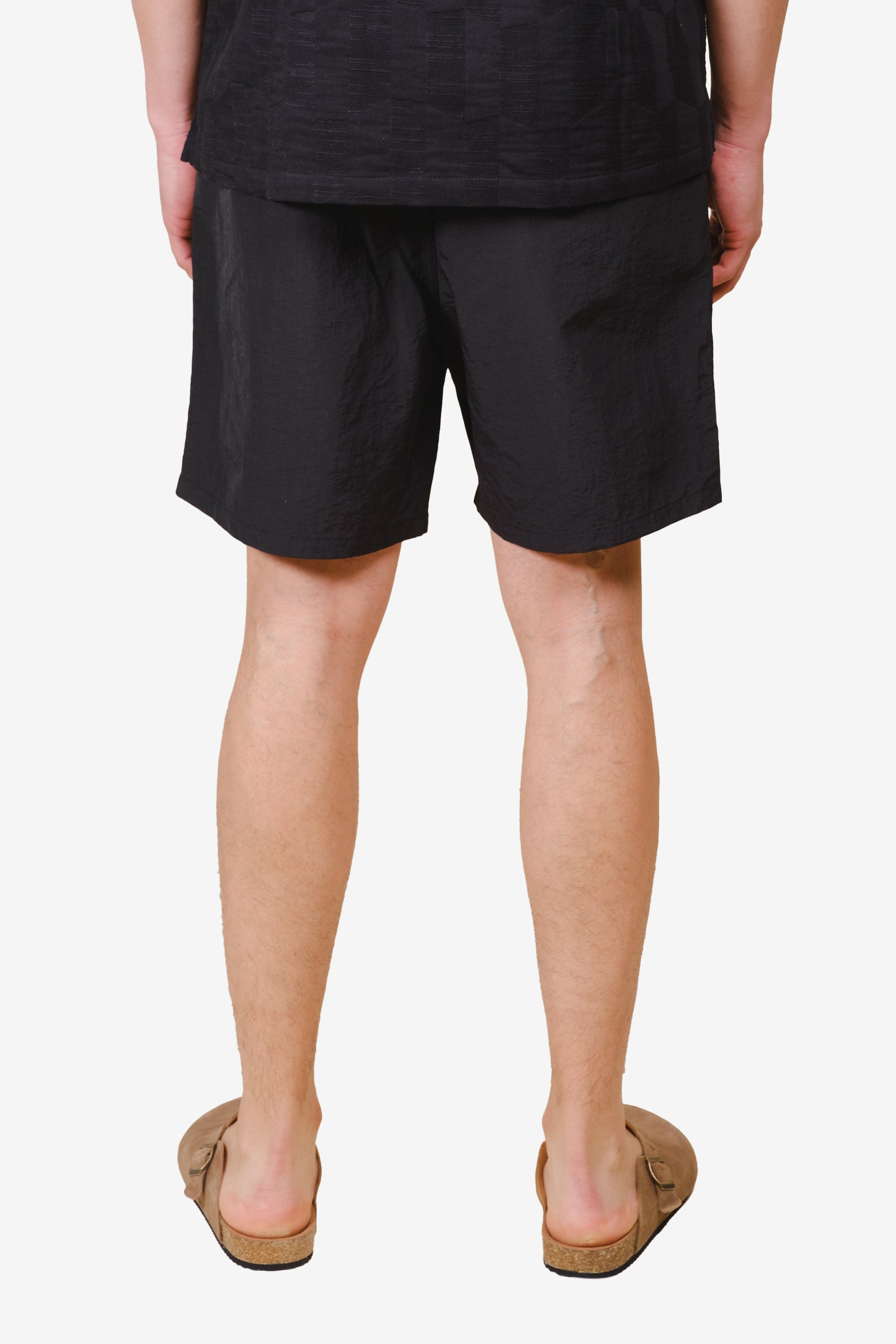 Men's black monotone crinkle nylon shorts #color_black