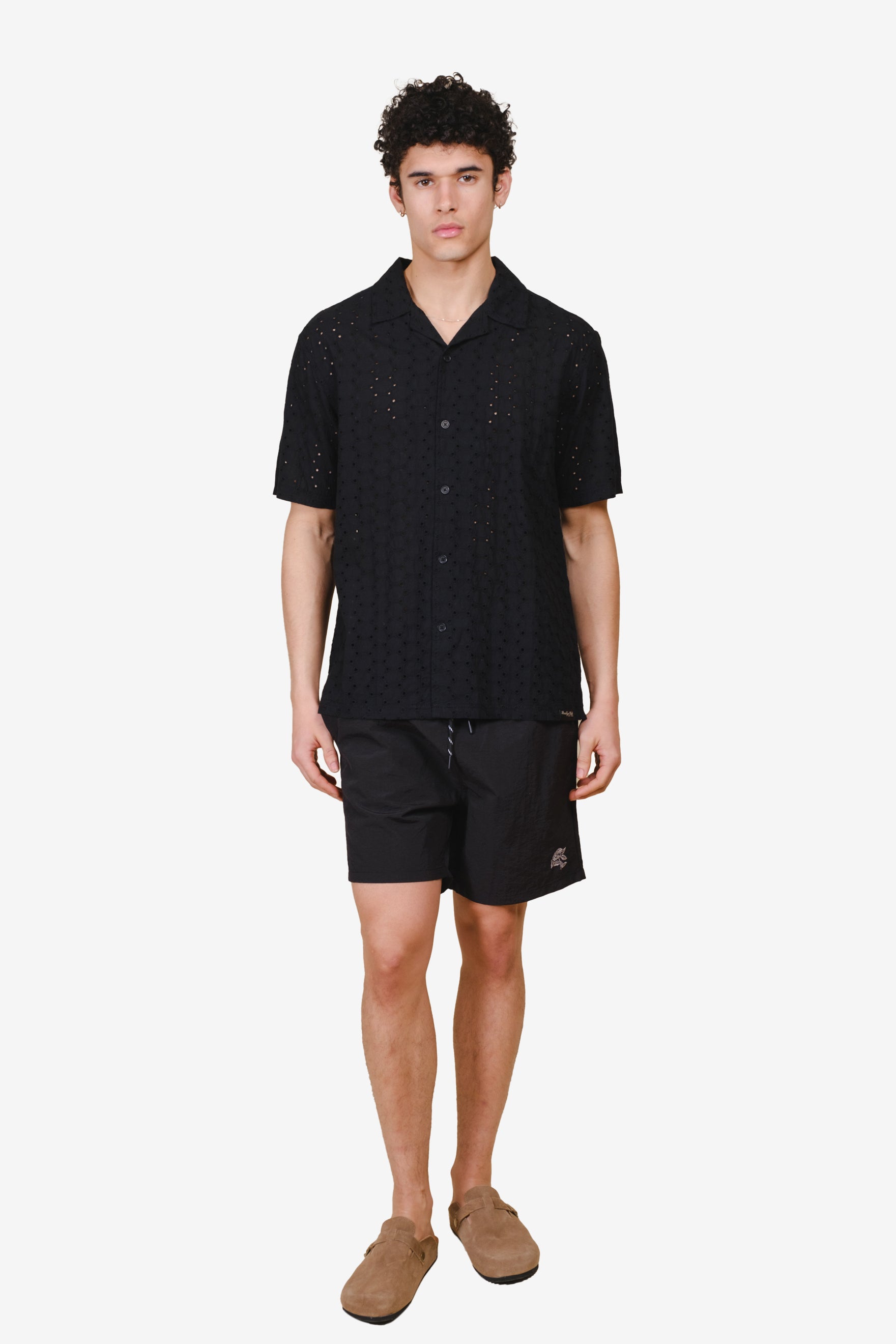 Monotone crinkle nylon shorts with comfortable elastic waist and small flower on lower right corner 
#color_black