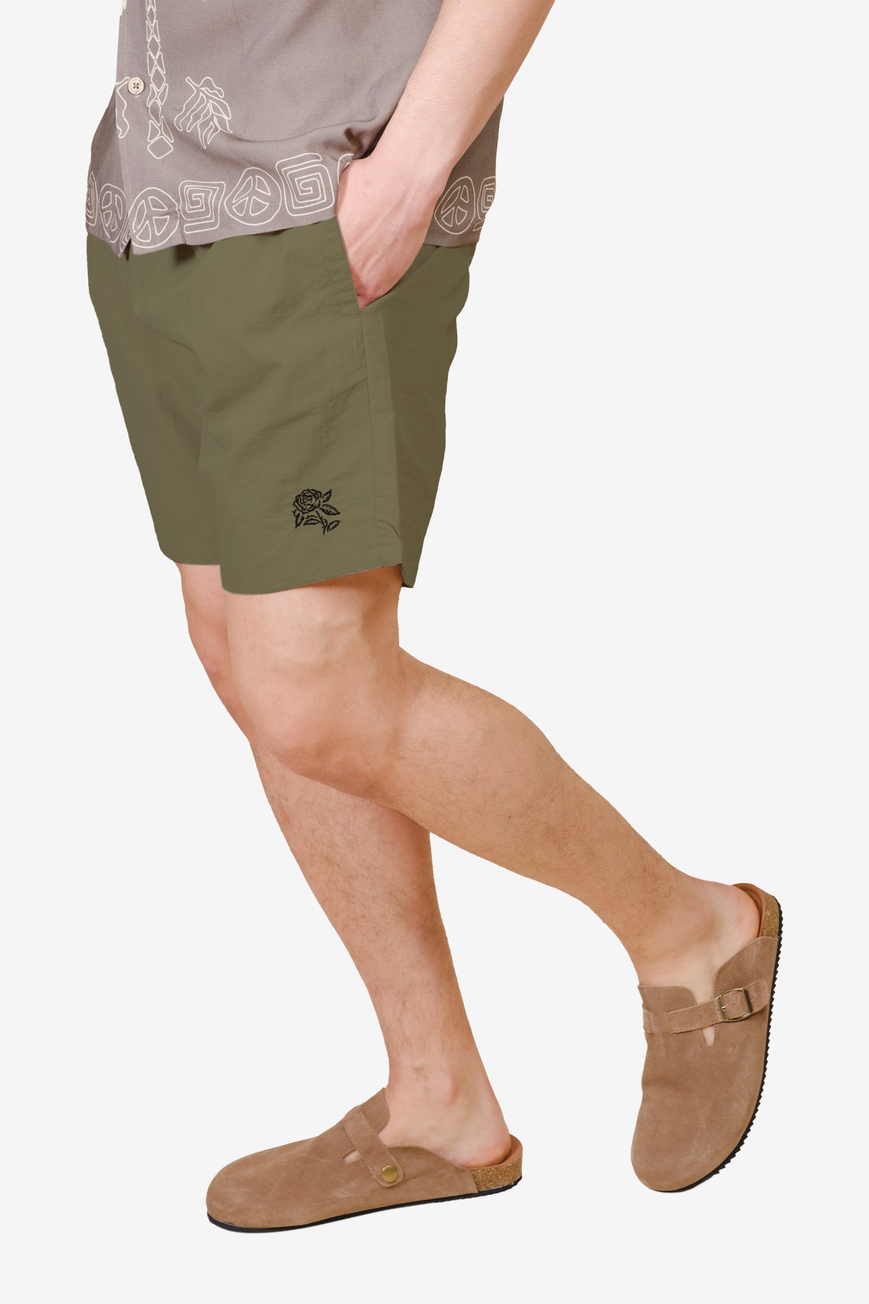 Comfortable monotone crinkle nylon shorts with subtle black flower on bottom right corner
#color_olive