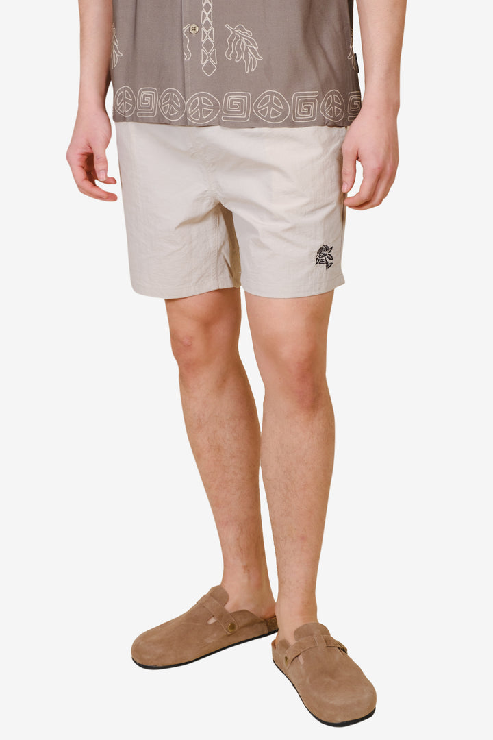 Men's monotone crinkle nylon shorts with flower detailing
#color_sand