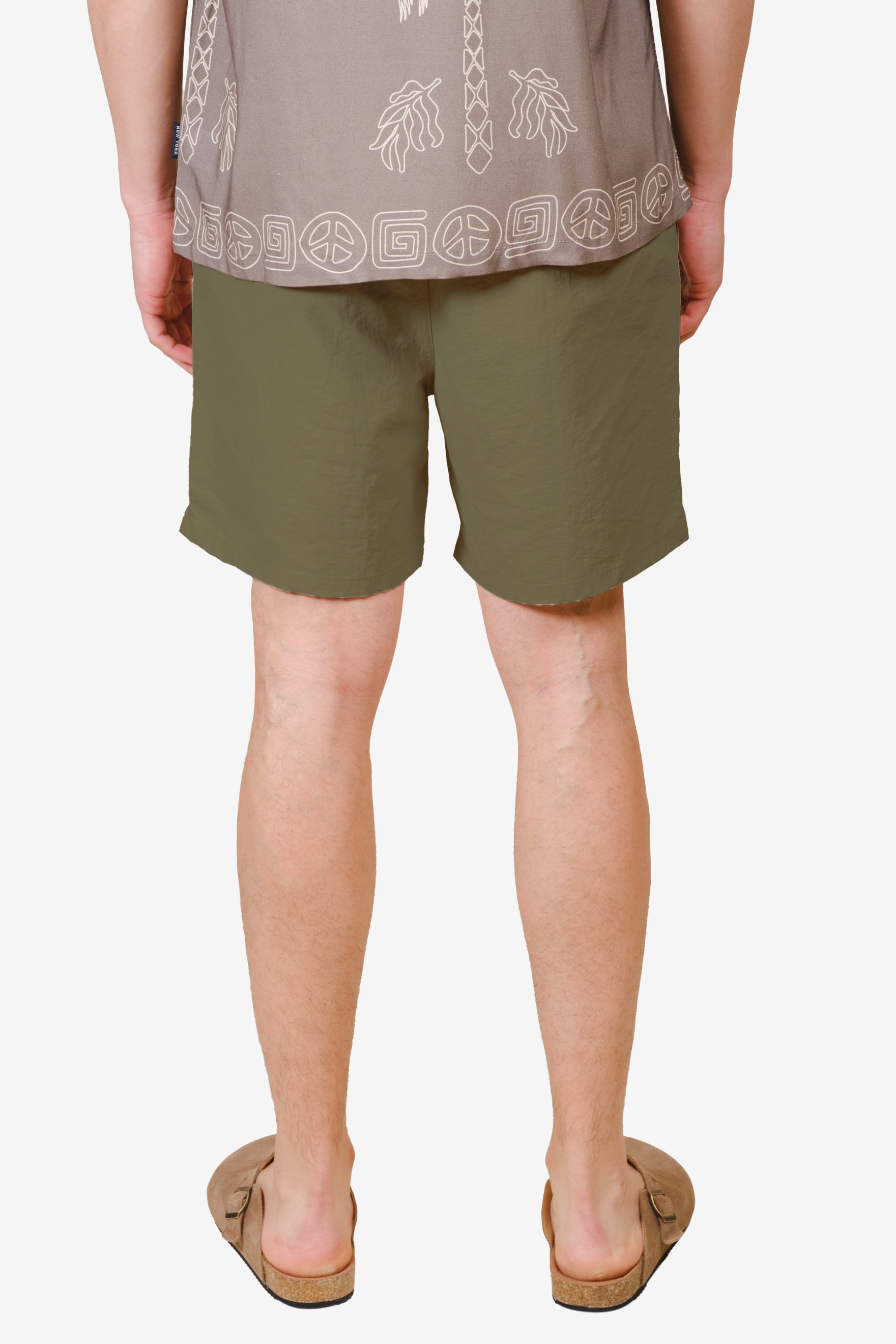 Men's olive monotone crinkle nylon shorts with flower detail on bottom right corner #color_olive