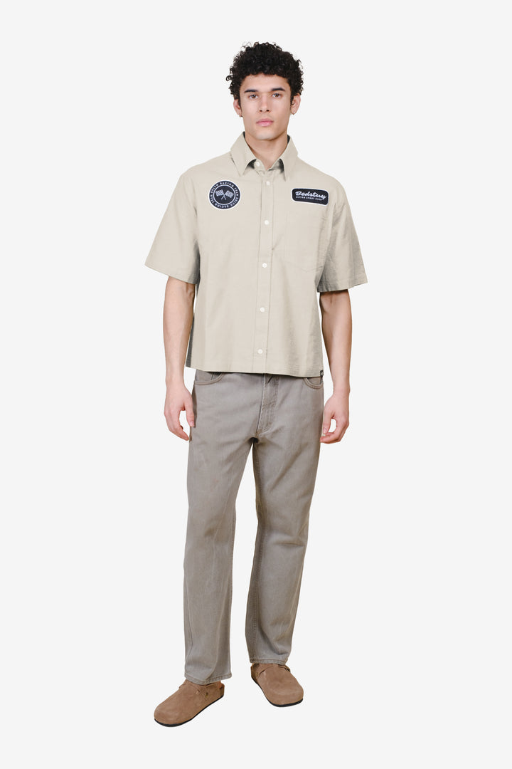 Cropped, boxy fit men's button up top with patch detailing 
#color_sand