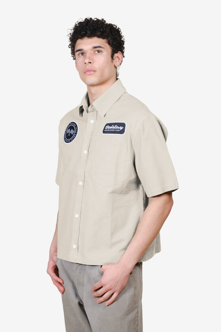 Men's cropped button up shirt with patch detailing on chest in sand color #color_sand