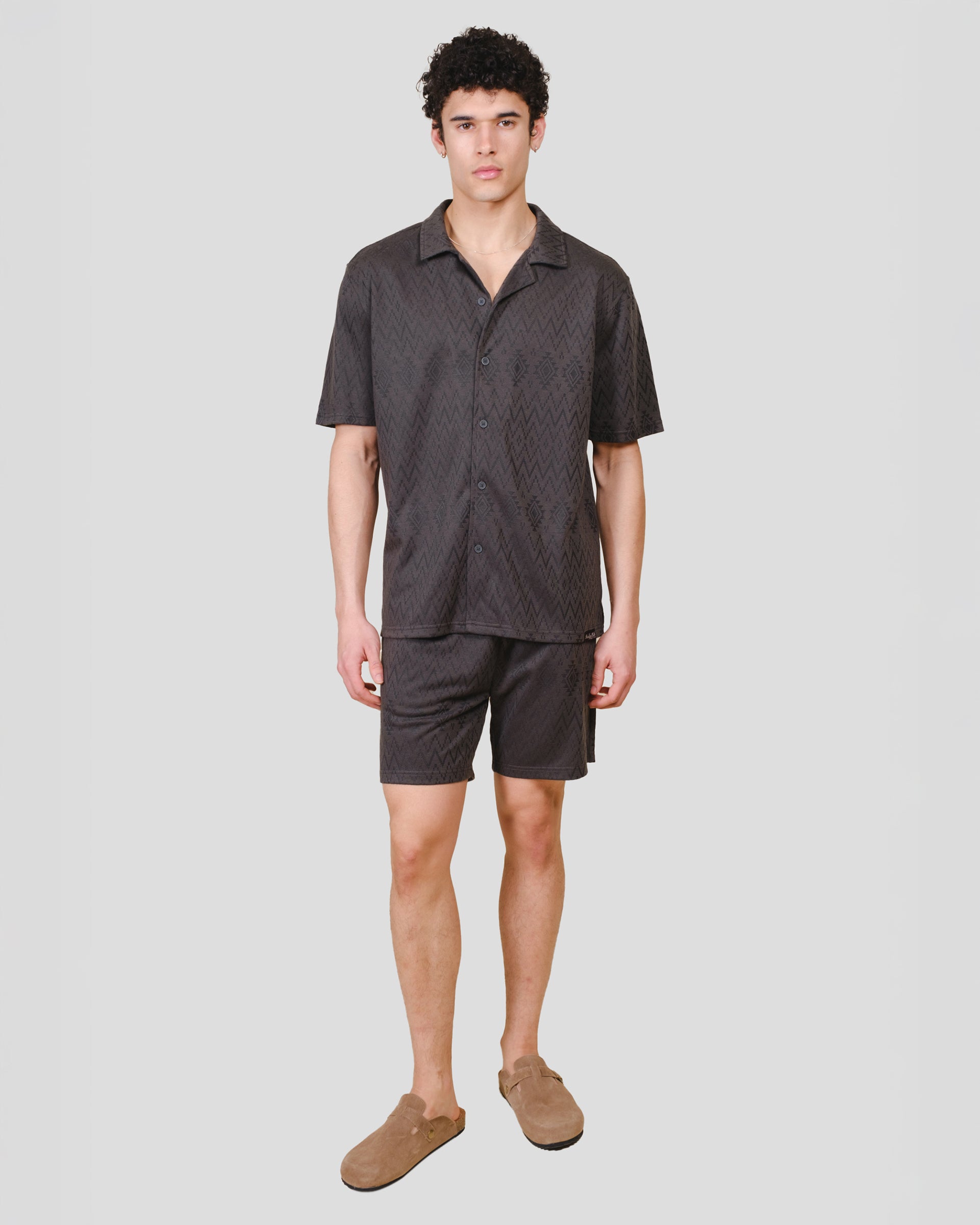 Mens dusty black knit shorts with an aztec jacquard pattern #color_dusty-black