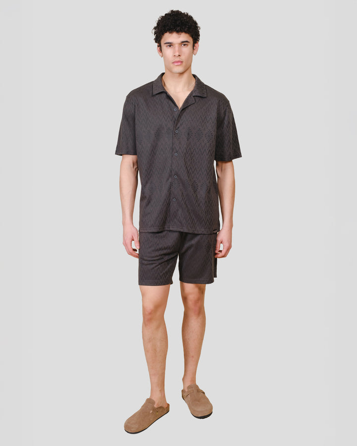 Mens dusty black knit shorts with an aztec jacquard pattern #color_dusty-black