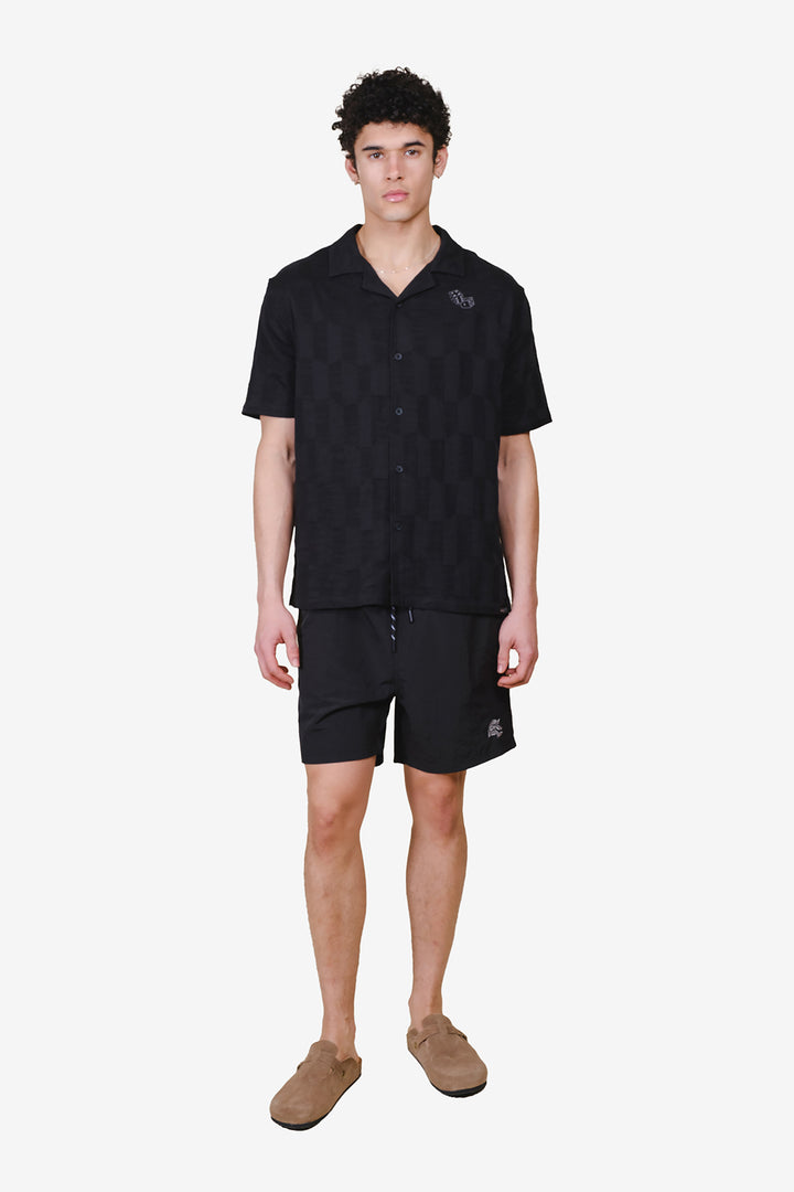 Men's relaxed fit button down woven top with camp collar and dice detail #color_black