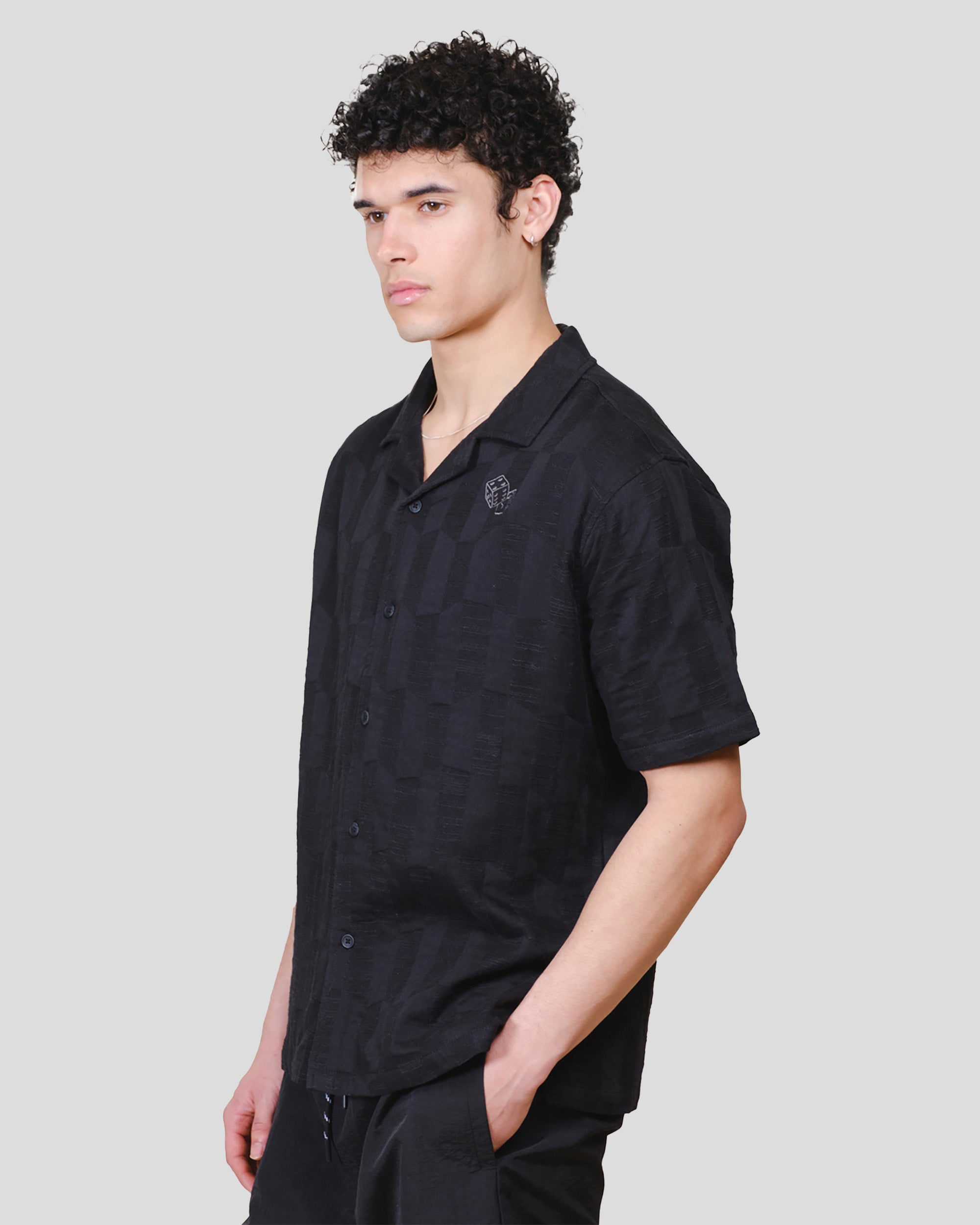 Woven Jacquard shirt with button down closure and embroidered dice detail 
#color_black