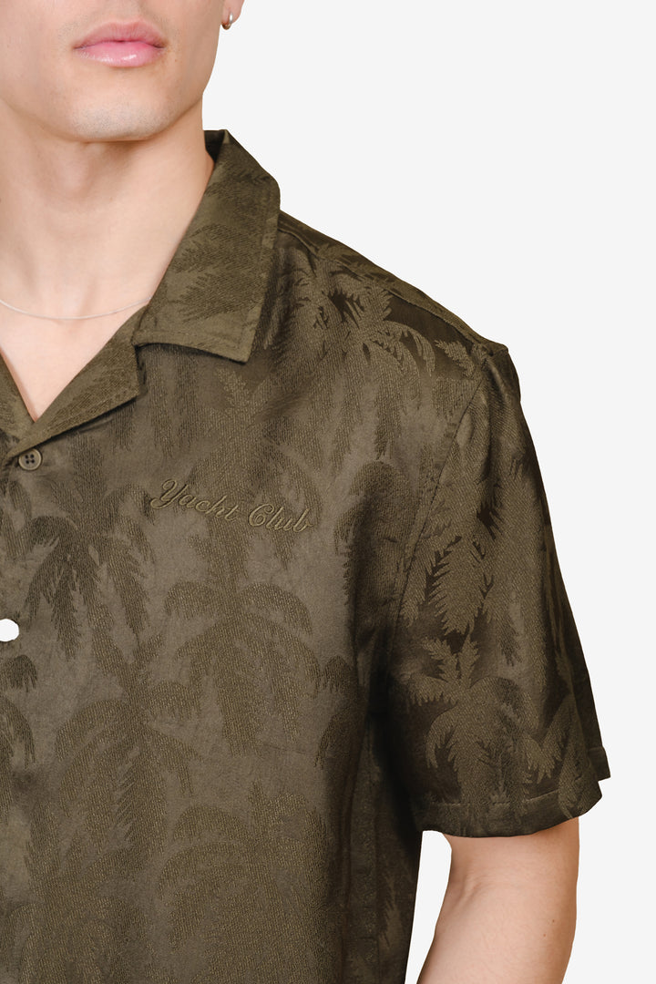 Men's camp collar shirt with button down front and graphic writing in corner 
#color_olive